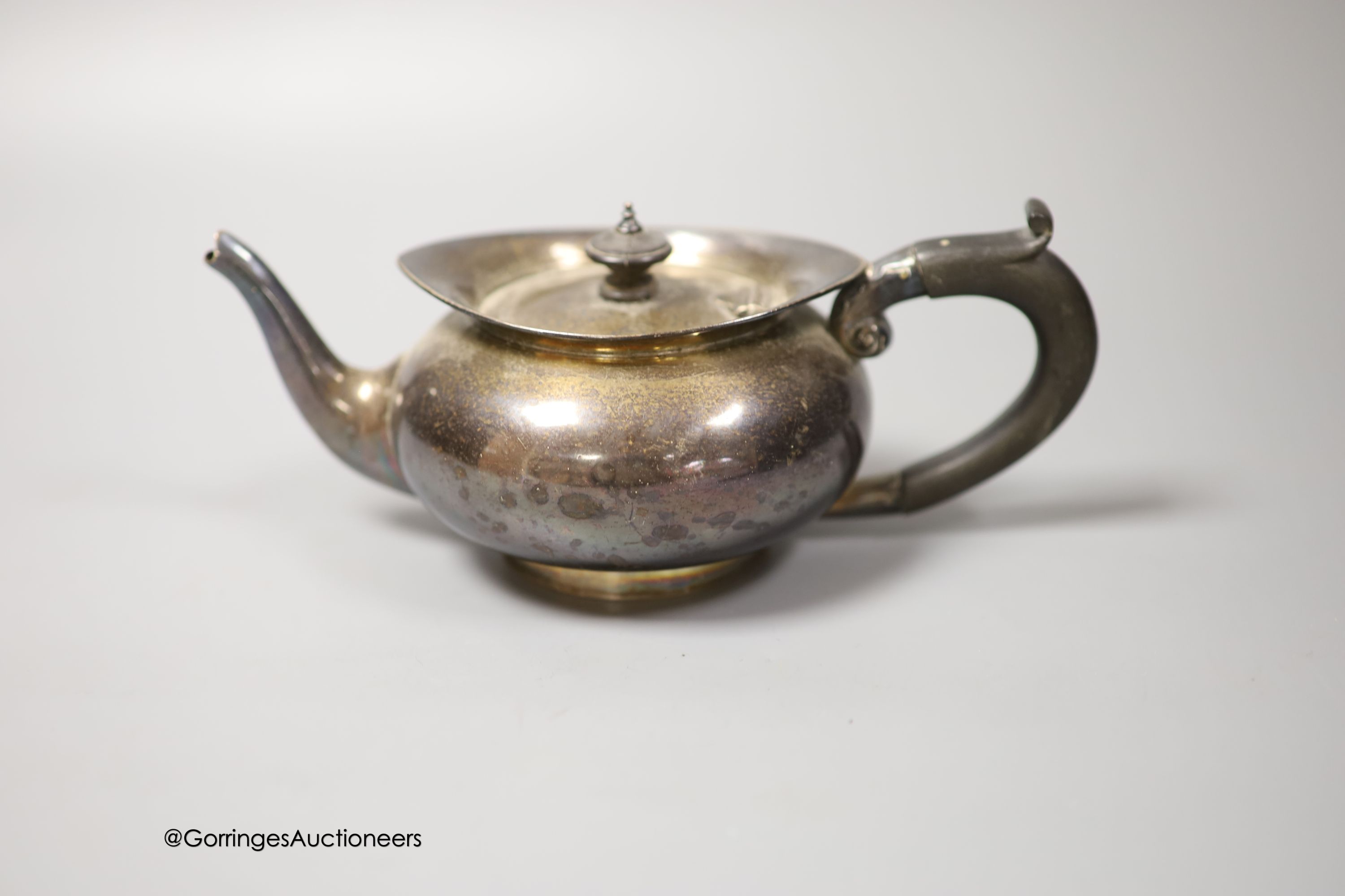 An Edwardian silver bachelor's squat circular teapot, T. Wooley, Birmingham, 1909, gross 9.5oz.